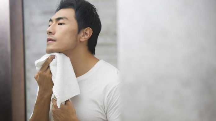 Young man shaving